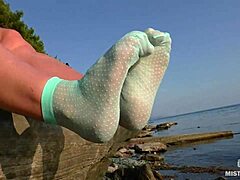 Cute lover flaunts toes in teasing turquoise nylon socks outdoors