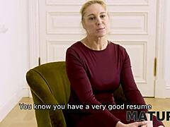A mature woman persuades a man to delay their interview for sexual encounter