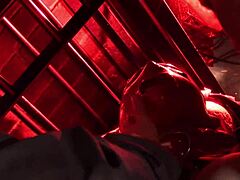 A girl in red latex mask gets fucked by two guys in a horror shop