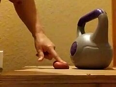 Fetish porn featuring wife busting balls with kettle bells